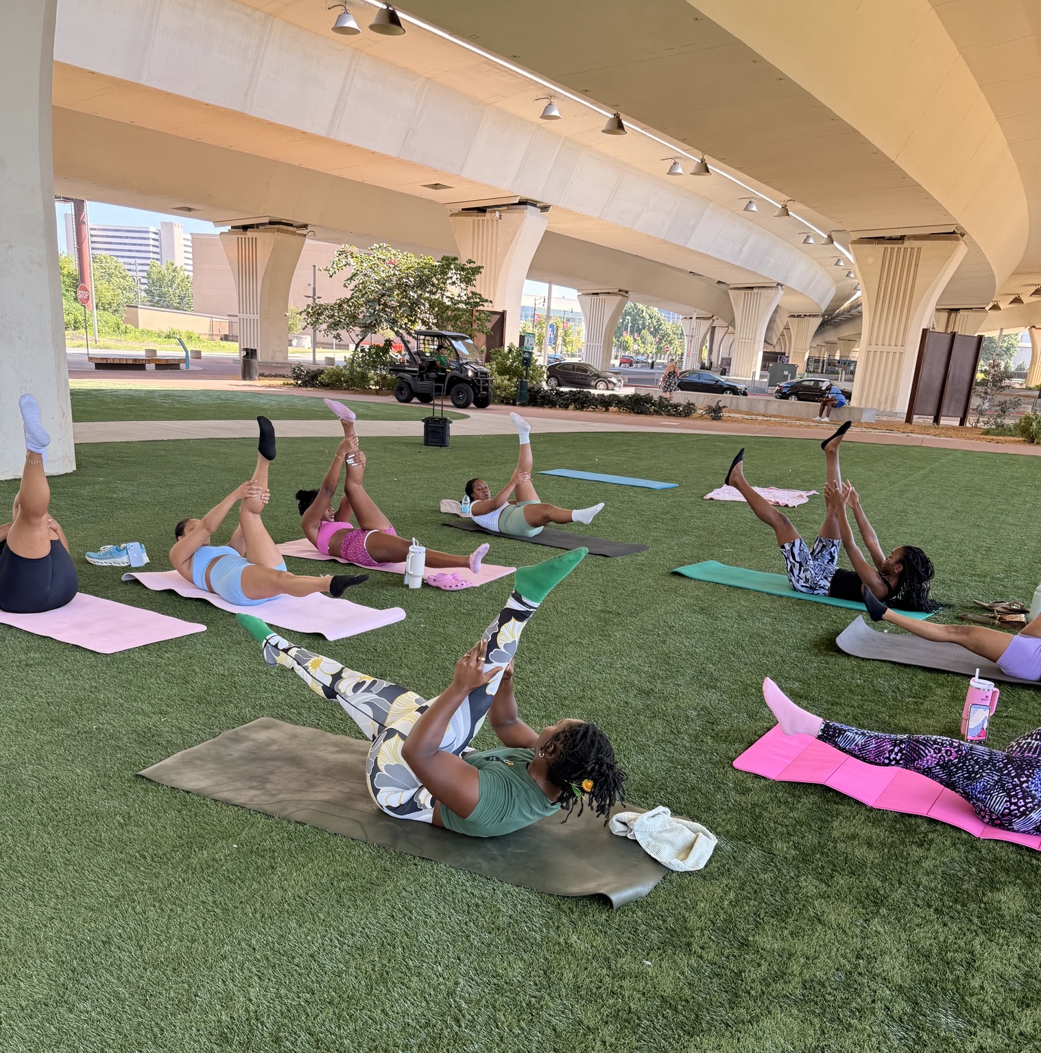 Group Pilates exercises on the lawn at City Walk