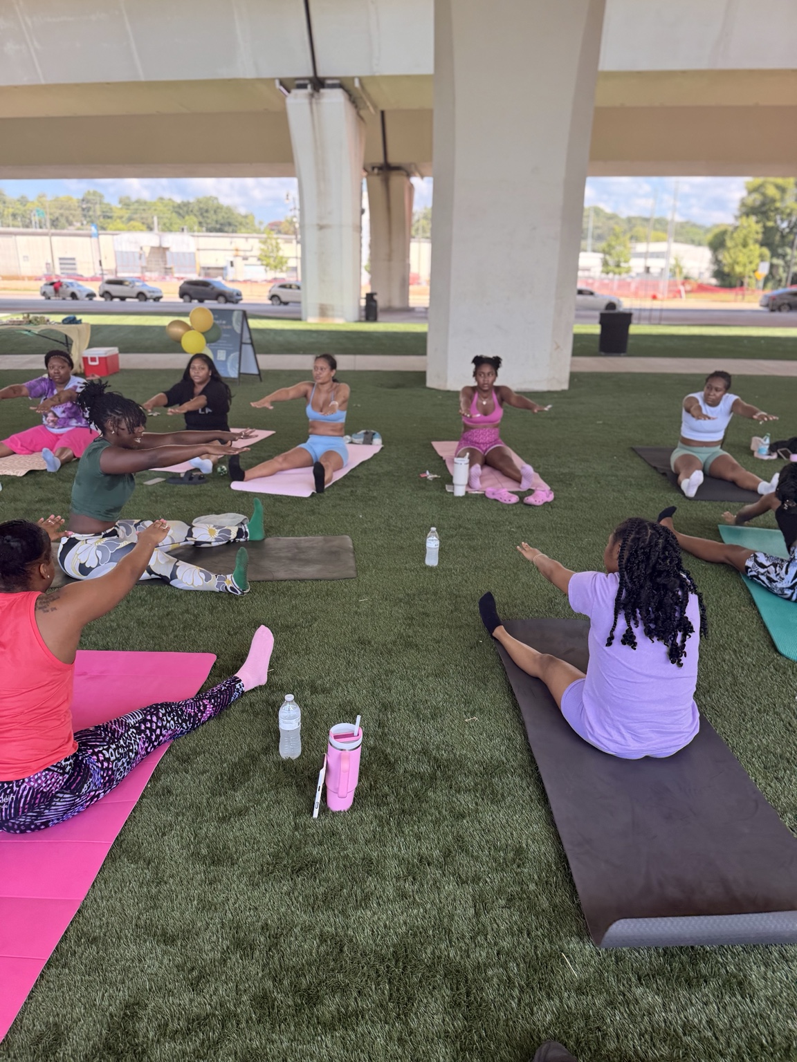Attendees stretching on mats during Community Pilates at City Walk